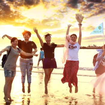 Girls jumping joyfully on a beach