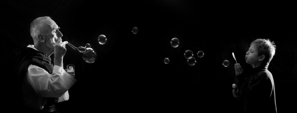 Br. David Steindl-Rast and a boy blowing bubbles by diego.ortiz.mugica
