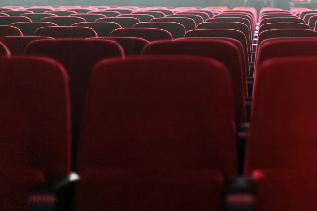 rows of empty red theater seats