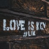 stencil graffiti with the phrase love is key